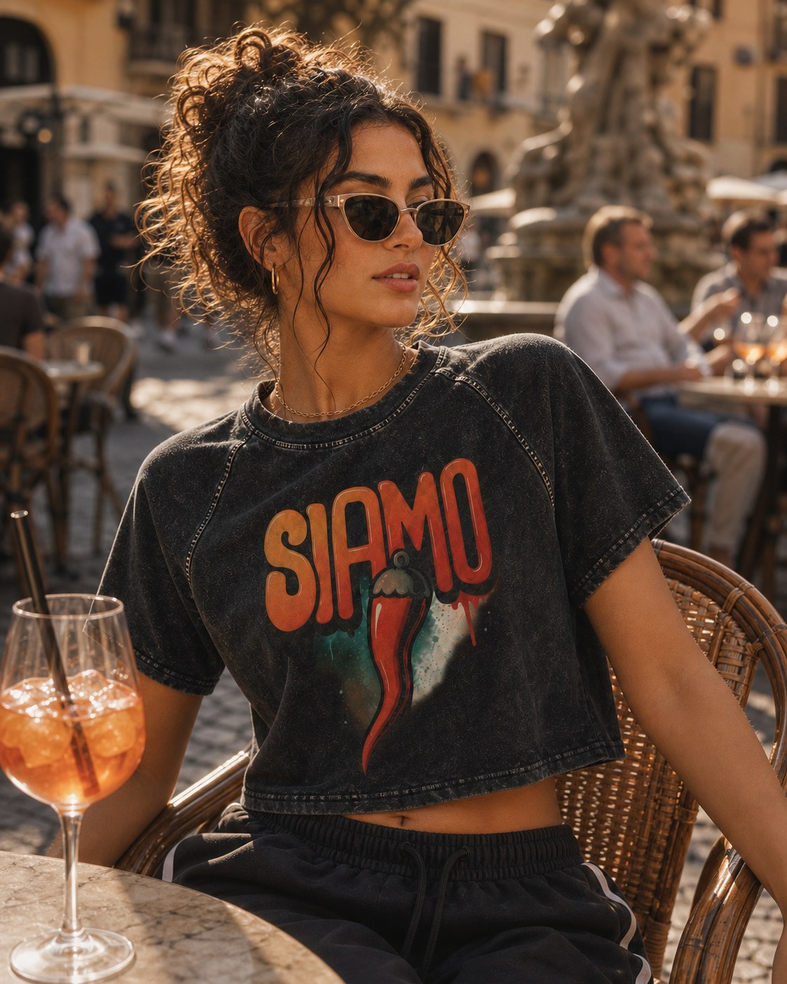 Editorial model wearing the SIAMO Corno Raglan Crop at a cafe